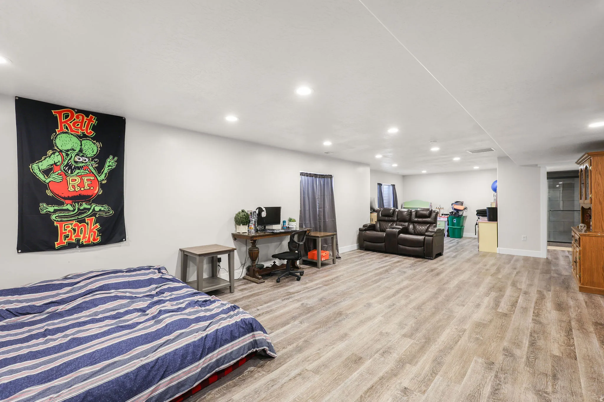 Bedroom with light wood-type flooring, recessed lighting, and a desk
