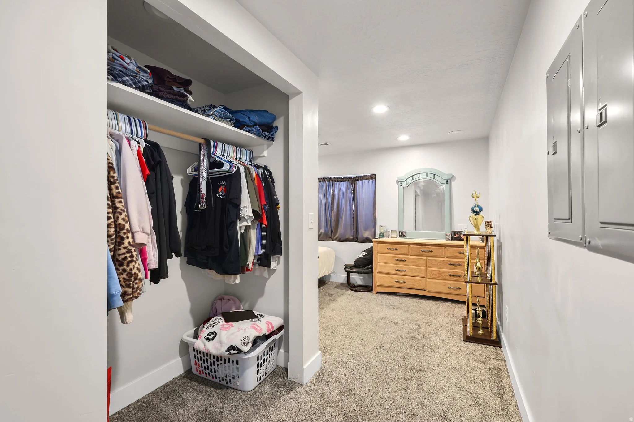Walk in closet featuring light colored carpet