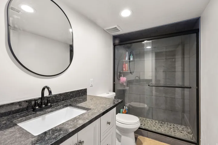 Full bathroom with vanity, a shower stall, recessed lighting, and tile patterned floors
