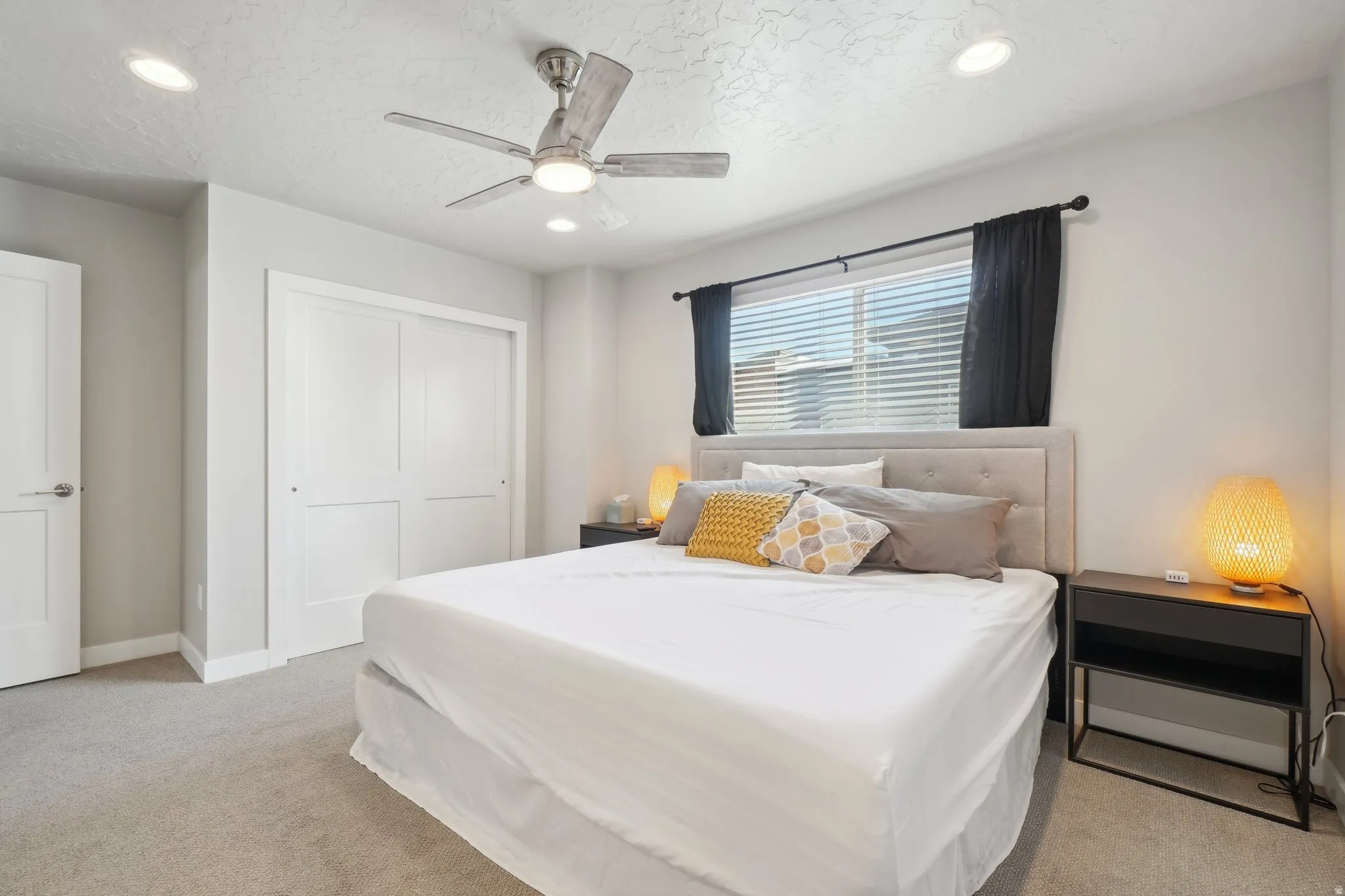 Bedroom featuring a closet, light carpet, a ceiling fan, and recessed lighting