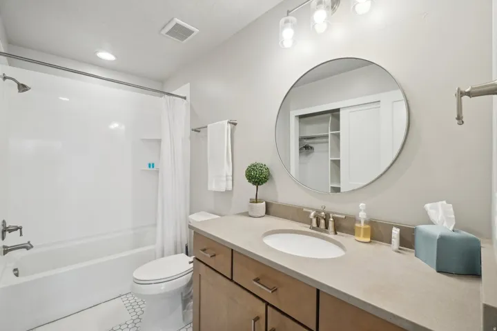 Bathroom featuring shower / tub combo, vanity, light tile patterned floors, recessed lighting, and a walk in closet