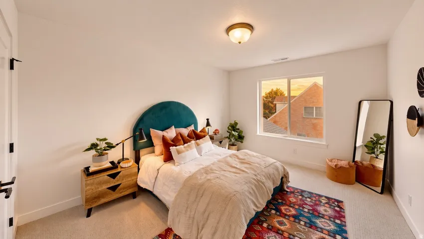 White wall finishes, recessed window, wall-mounted light fixture, carpeted flooring, and a white door with black hardware