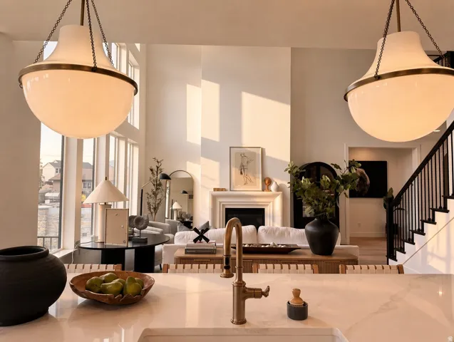 Kitchen island with an undermount sink, brass faucet, and stone countertop