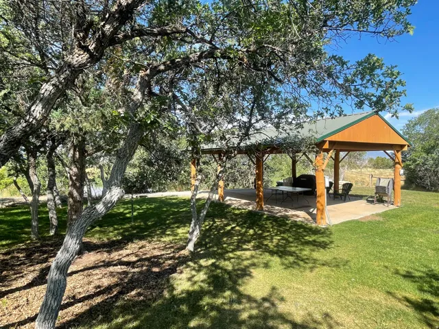 View of grassy yard with a patio area