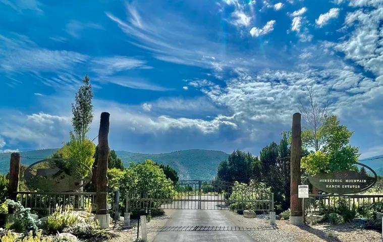 View of road with a gate, a gated entry, and a mountain view