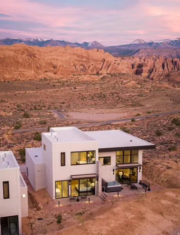 View of front of property featuring a patio area, a mountain view, and stucco siding