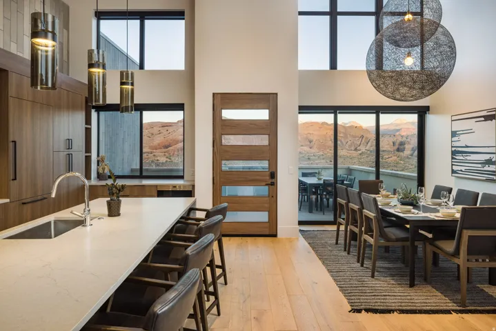 Dining area with light wood-type flooring and a towering ceiling
