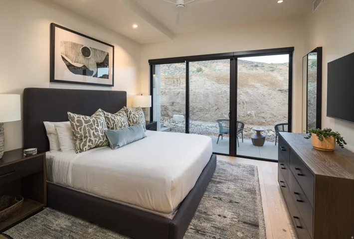 Bedroom with light wood-type flooring, recessed lighting, and access to outside