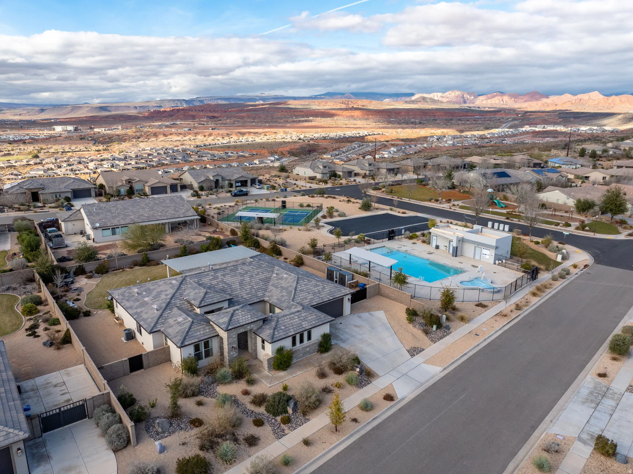 Aerial perspective of suburban area featuring mountains and a pool area