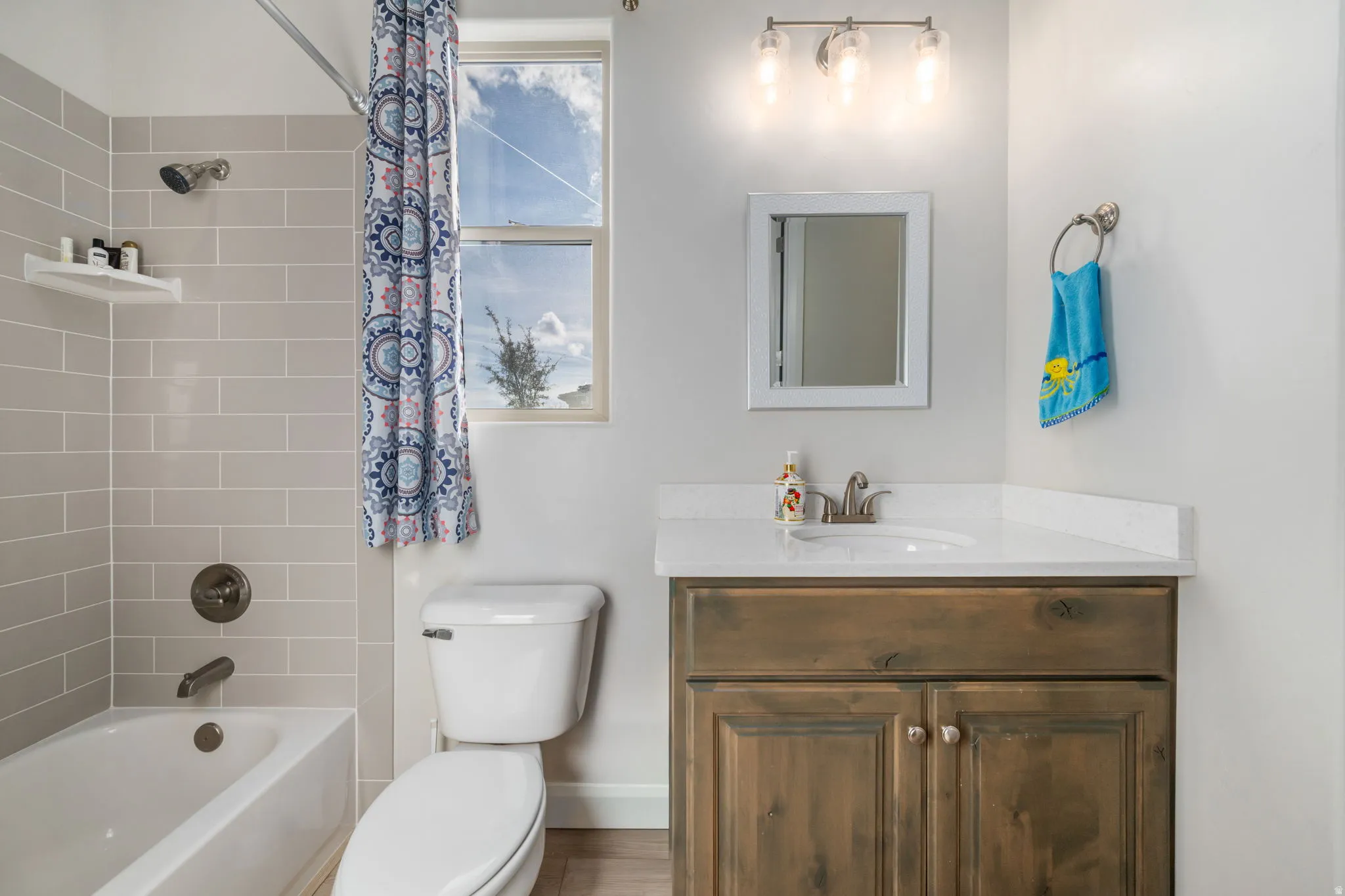Bathroom with shower / bath combo with shower curtain and vanity