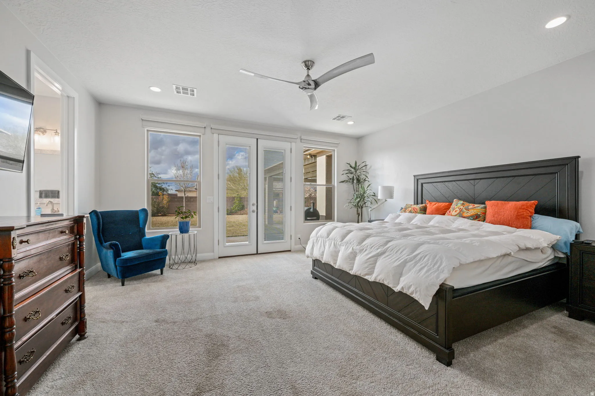Bedroom with access to exterior, light carpet, a ceiling fan, and recessed lighting