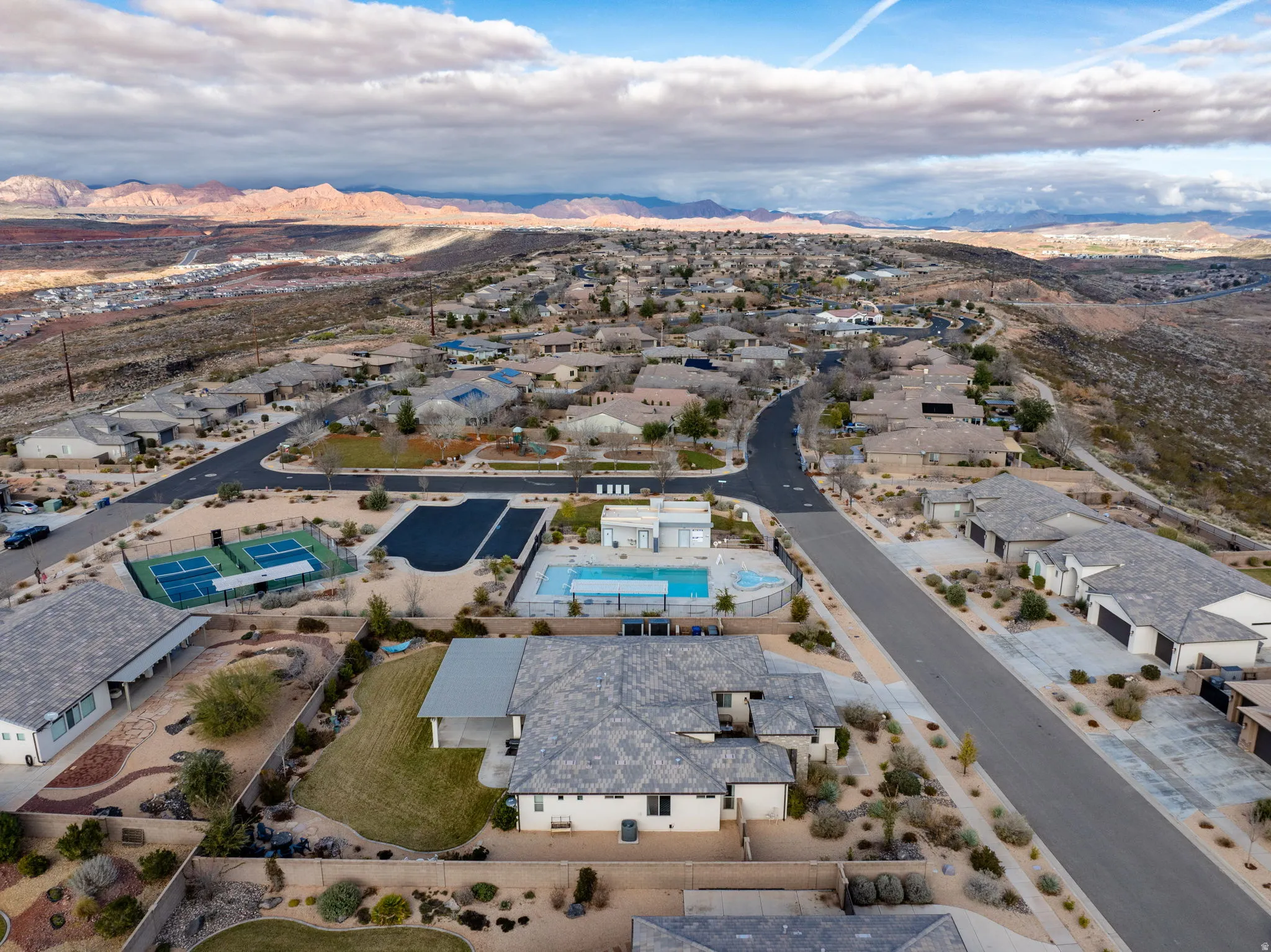 Aerial overview of property's location featuring a mountainous background and nearby suburban area