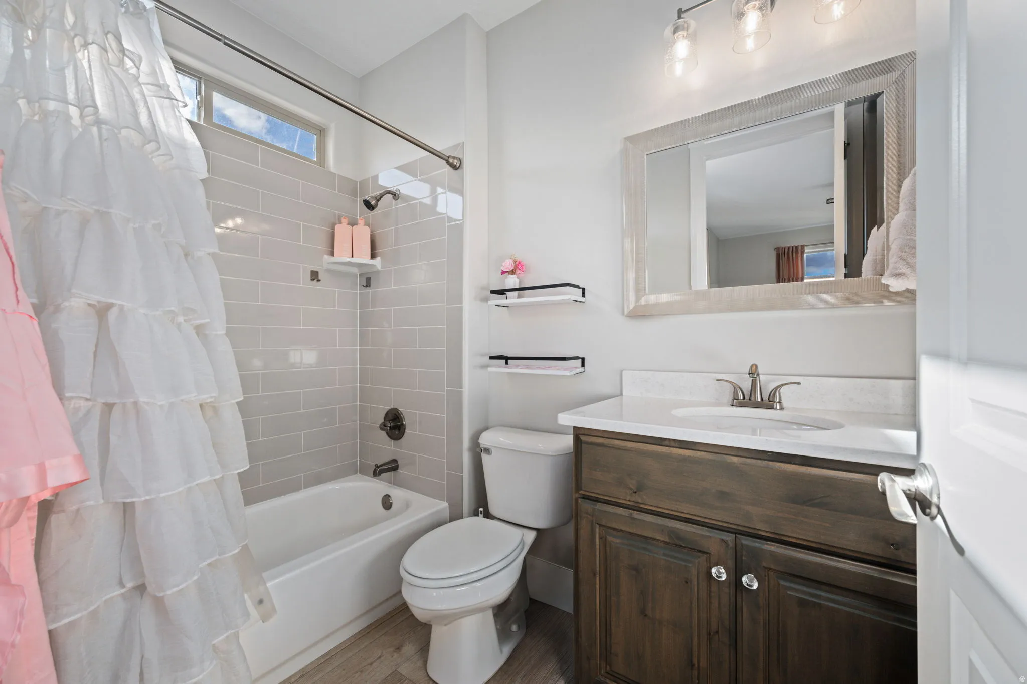 Bathroom with vanity and shower / bath combination with curtain
