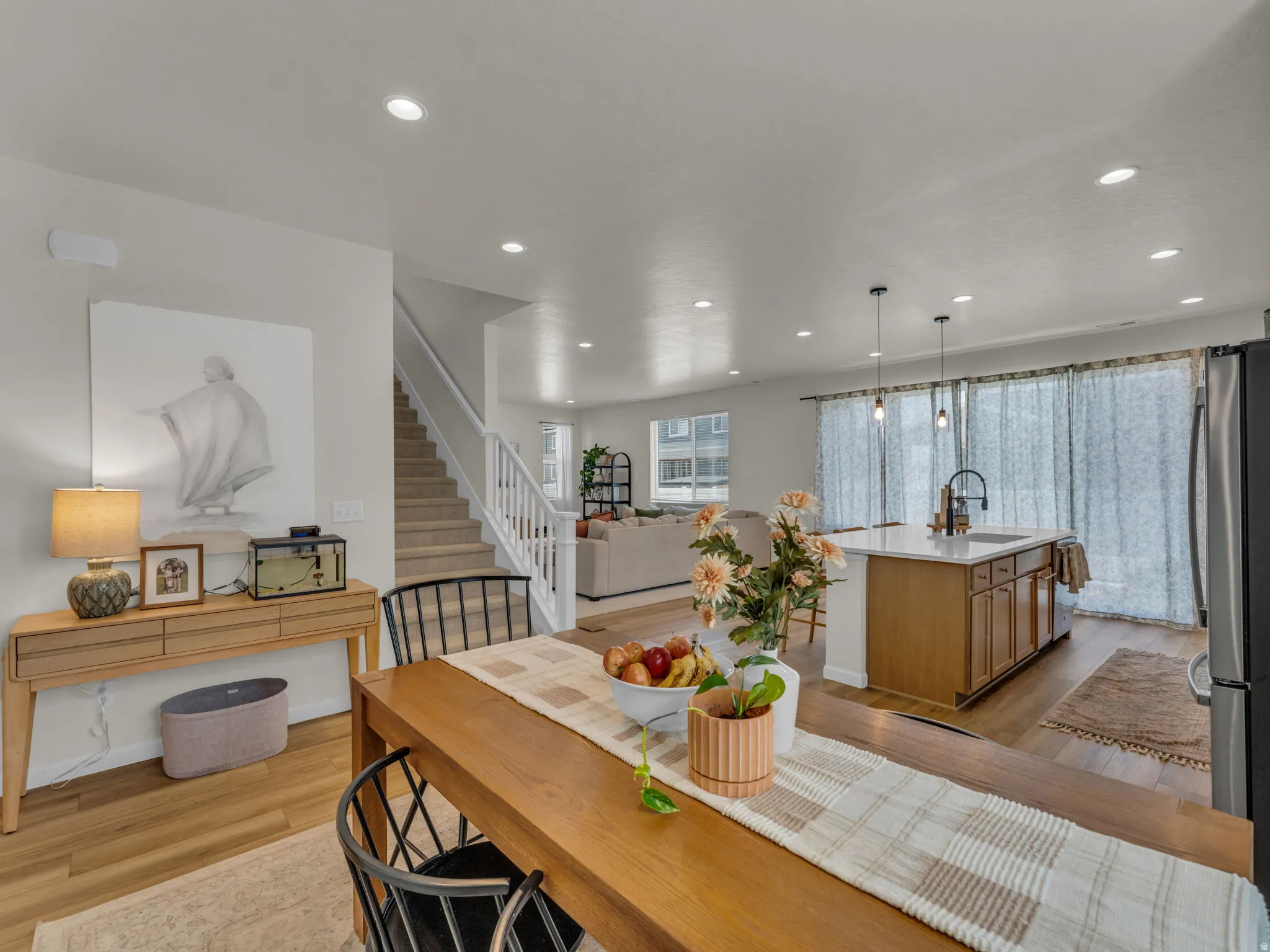 Dining space featuring light wood-style floors, stairs, and recessed lighting