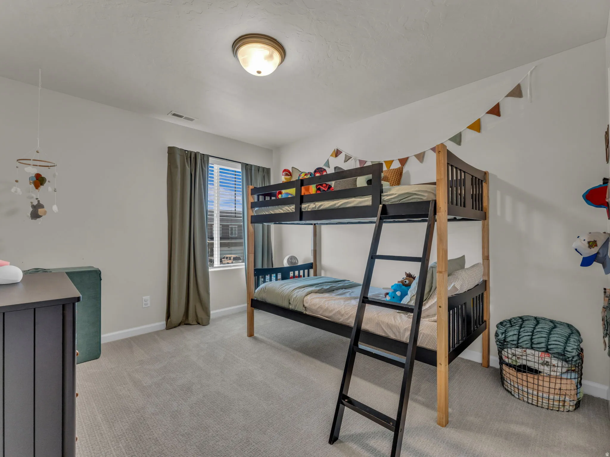 Bedroom featuring light colored carpet and baseboards