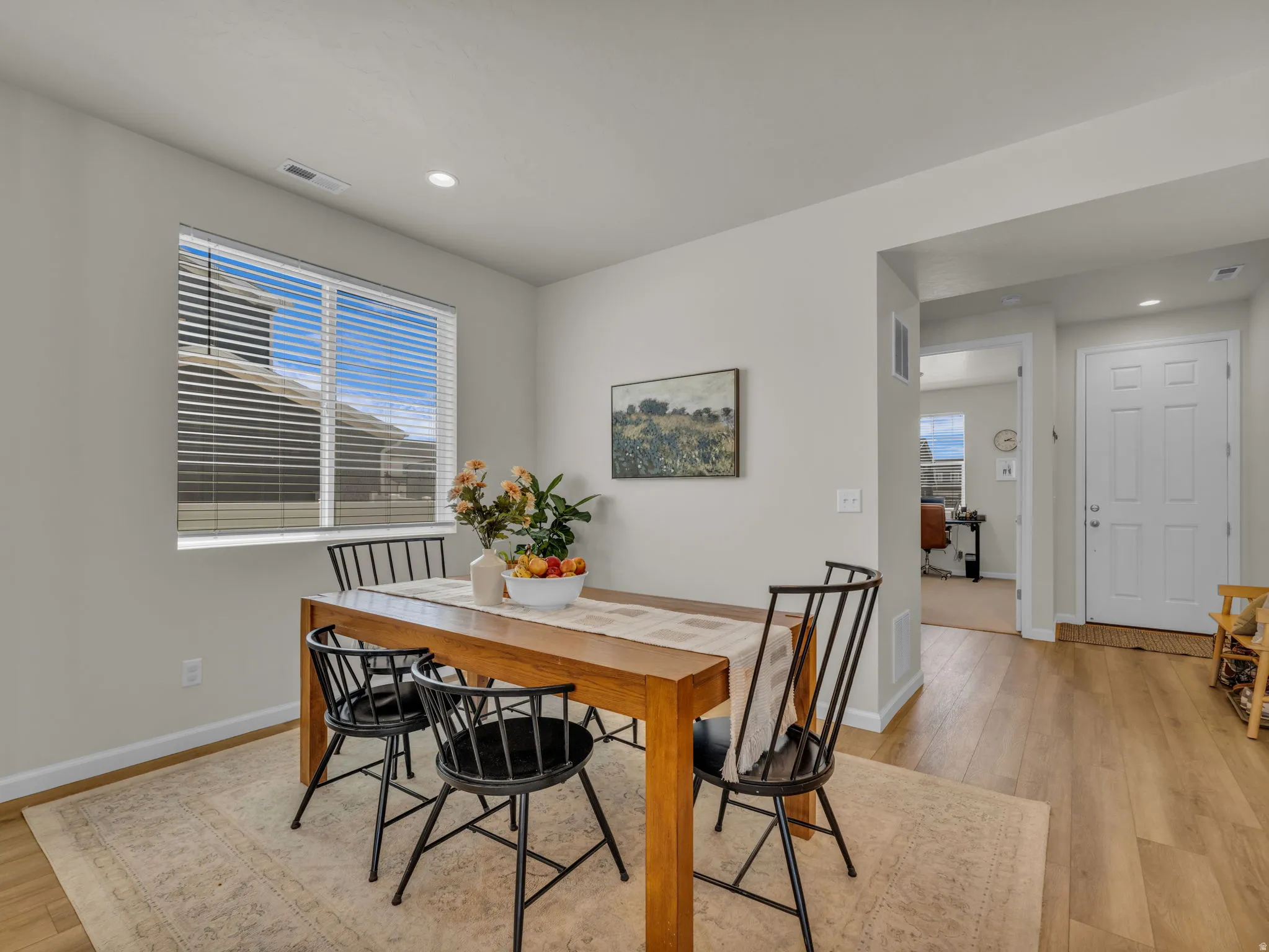 Dining space featuring light wood-style floors and recessed lighting
