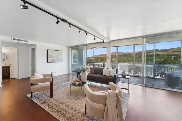 Living area featuring full-height glass doors opening to a balcony