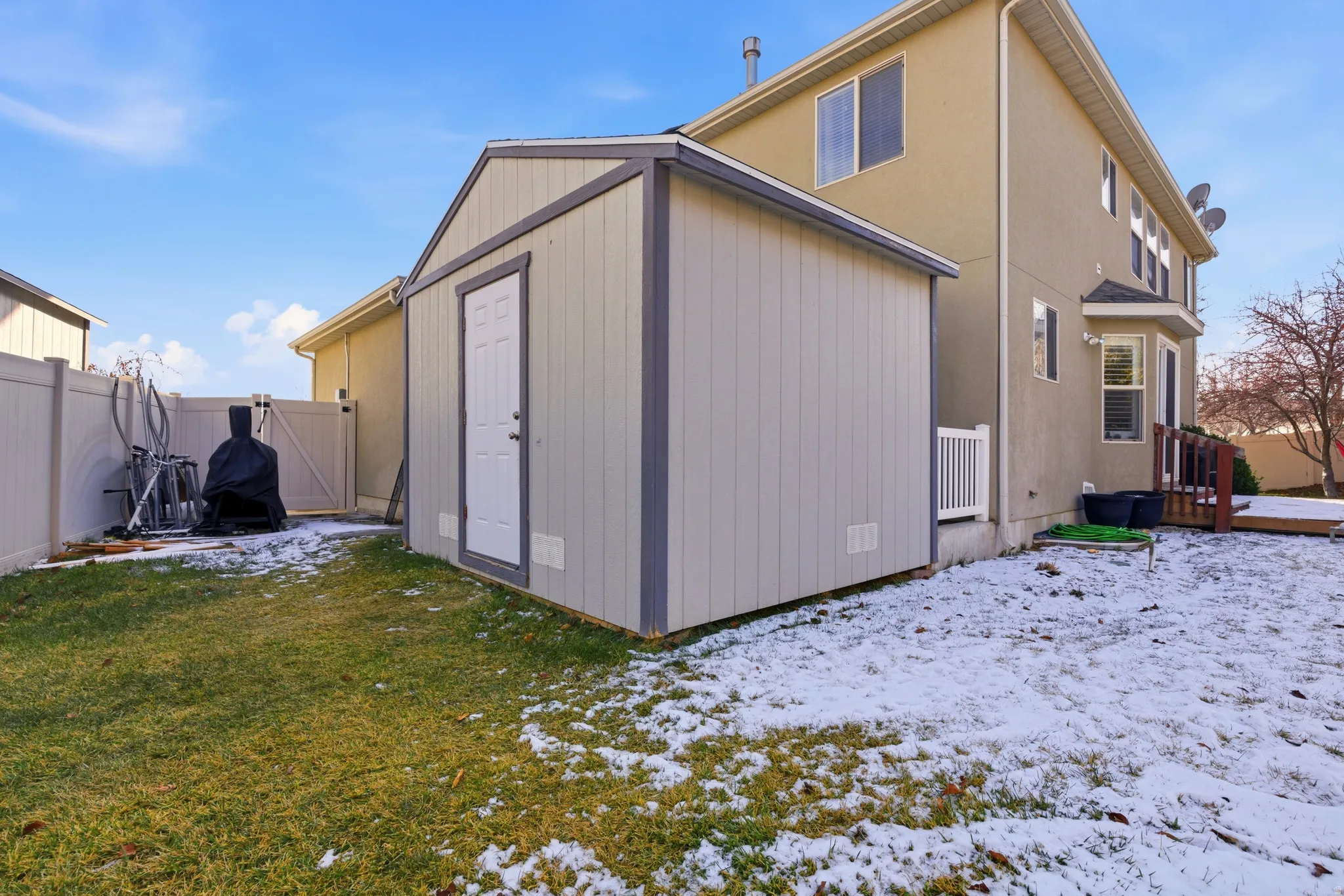 Rear view of property with an outbuilding and a fenced backyard