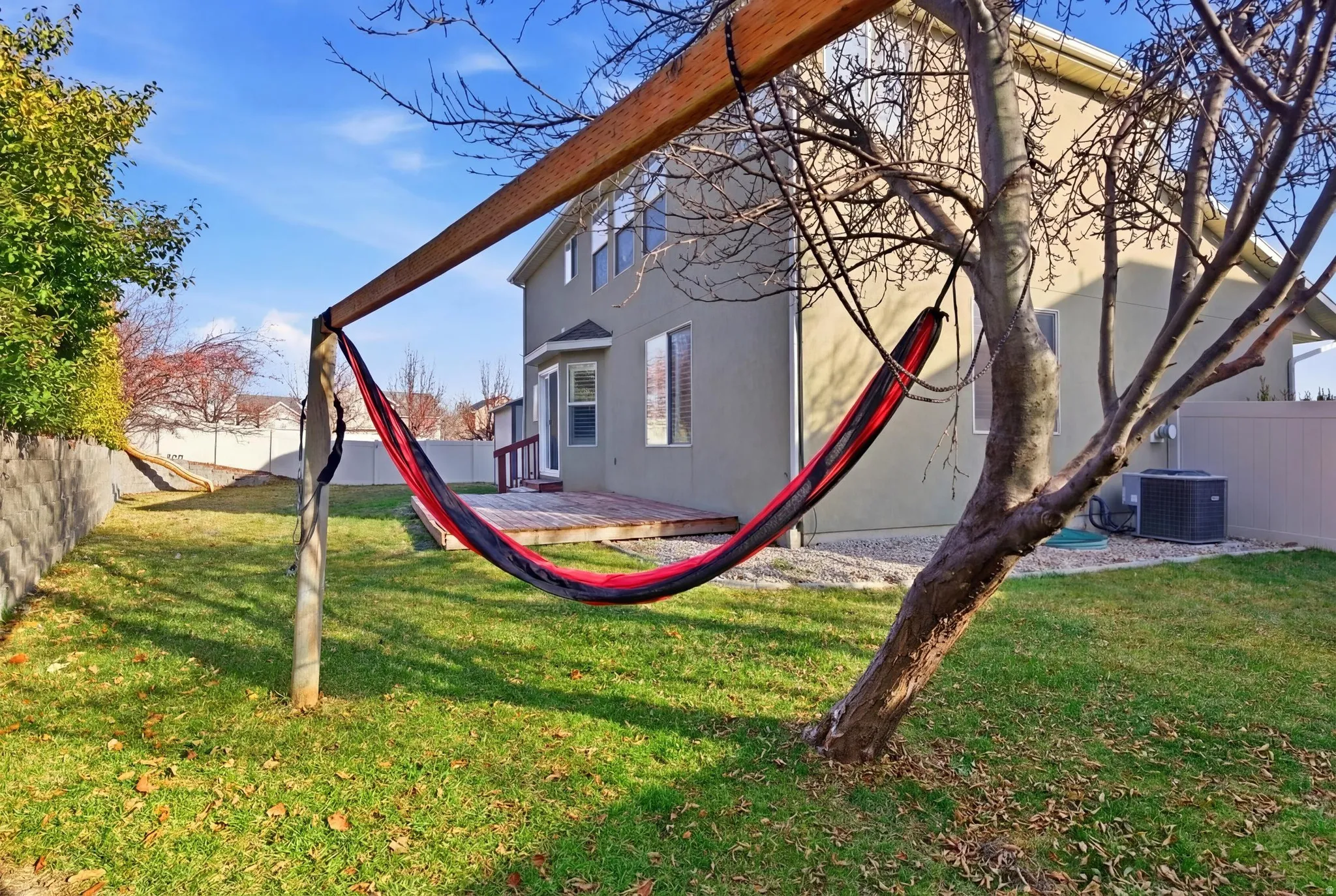 Fenced backyard with a wooden deck