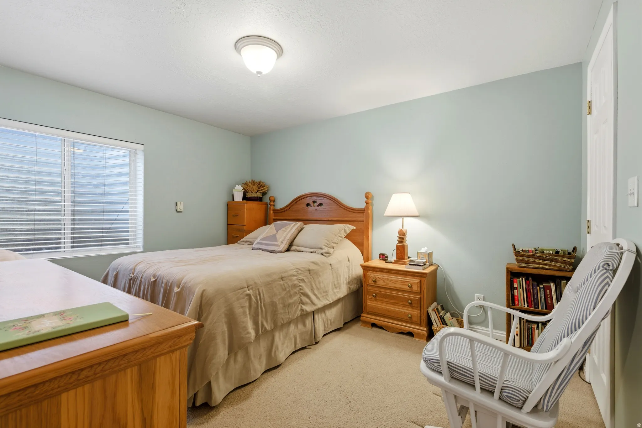 Bedroom featuring light colored carpet