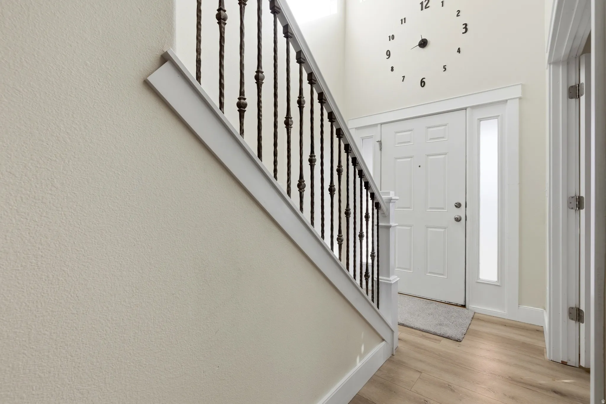 Entrance foyer featuring light wood finished floors and stairs