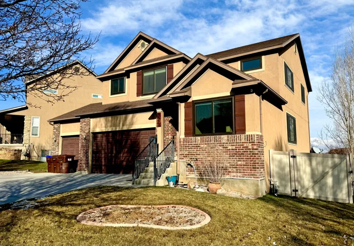 Craftsman inspired home with brick siding, concrete driveway, stucco siding, and a garage