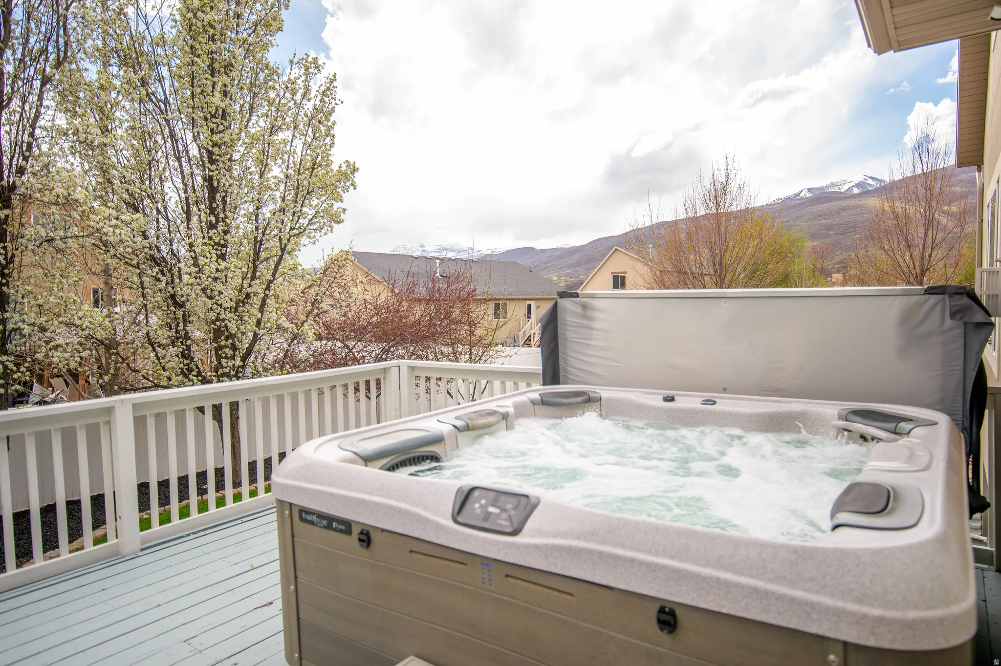 Wooden terrace with a hot tub and a mountain view