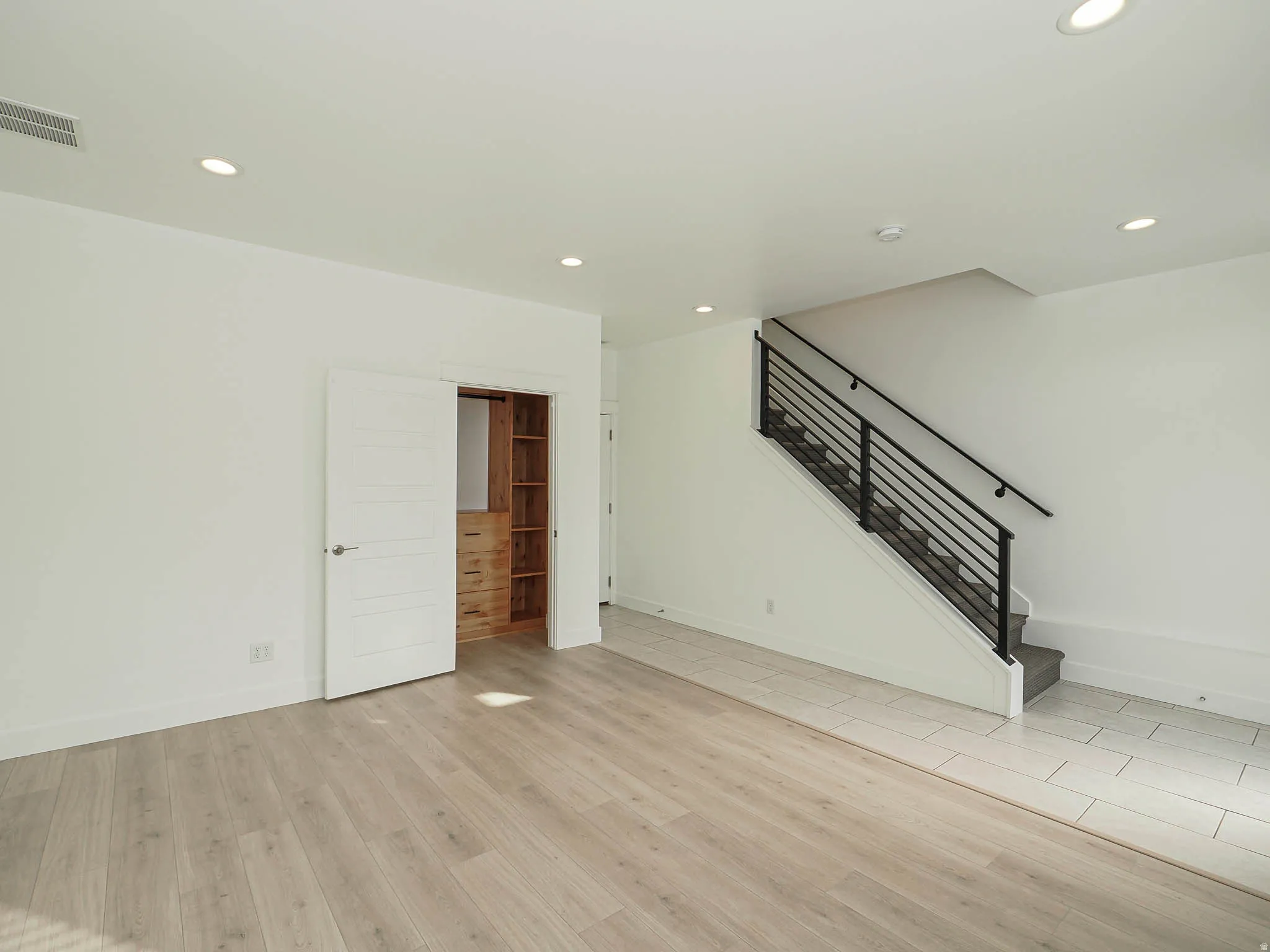Main floor den/office/bedroom with built-ins in closet.
