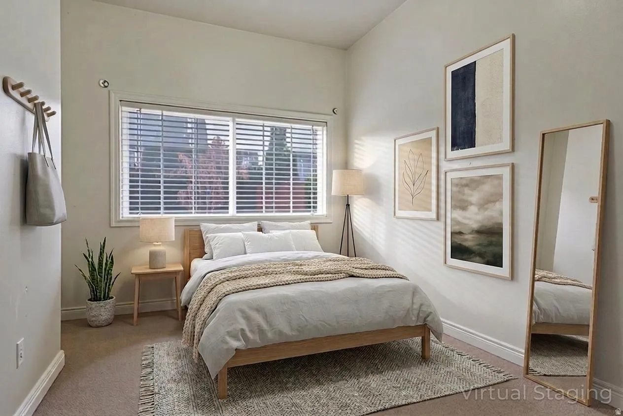 Bedroom with light carpet and baseboards