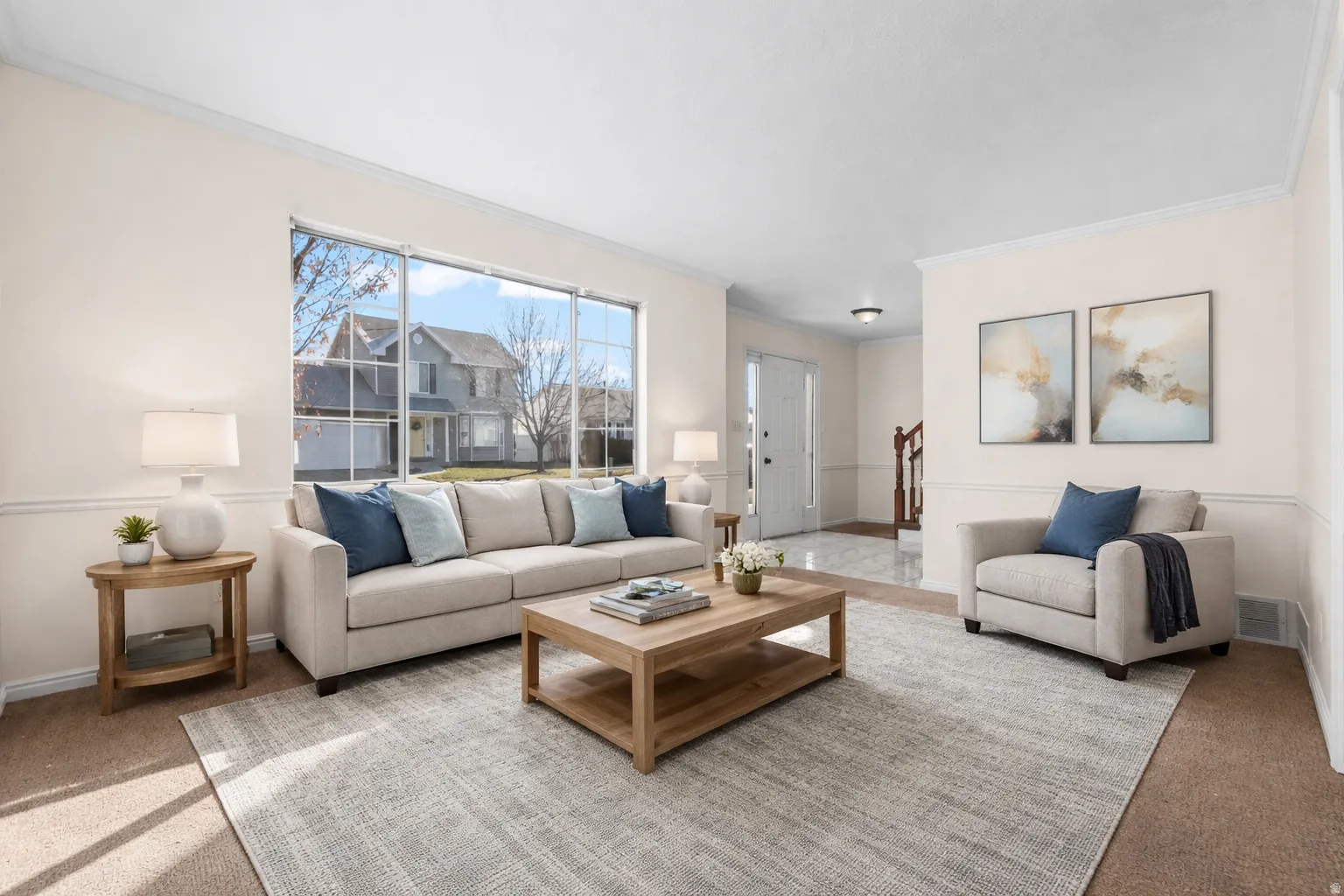 Carpeted living room with baseboards and crown molding