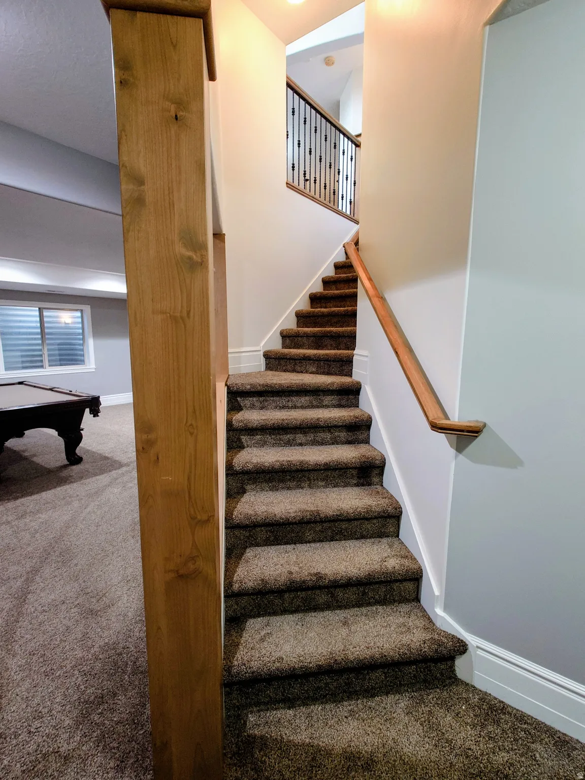 Stairs featuring carpet flooring and billiards