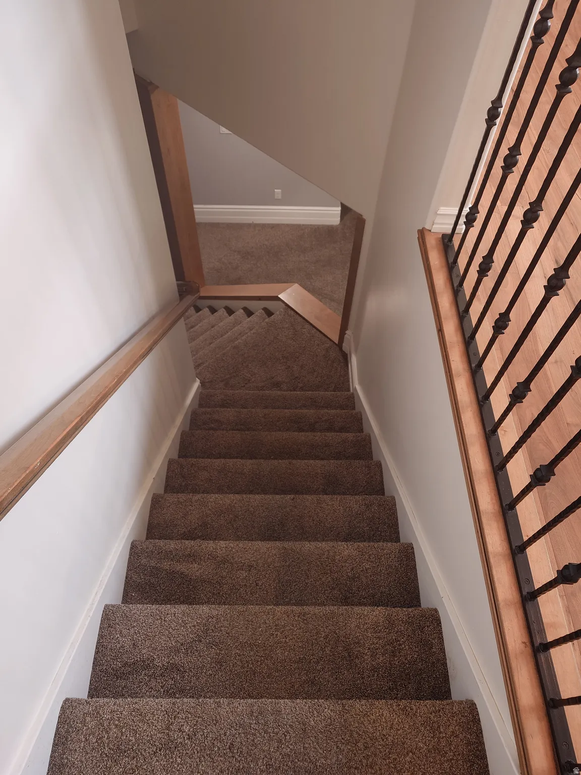 Stairs with carpet and baseboards