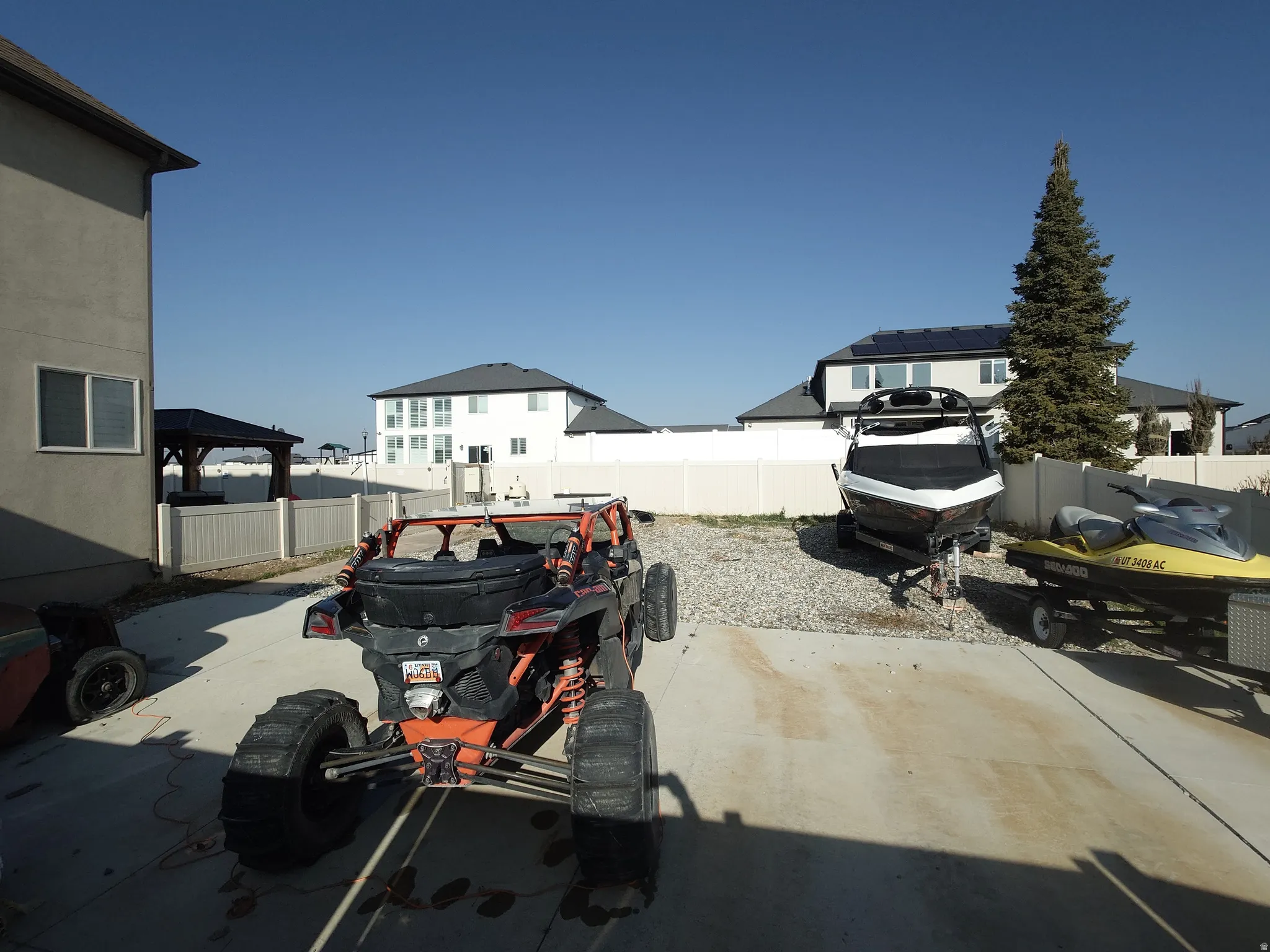 View of parking / parking lot with a fenced backyard