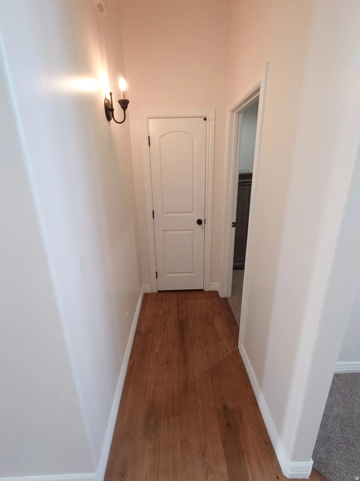 Hall featuring baseboards and dark wood finished floors