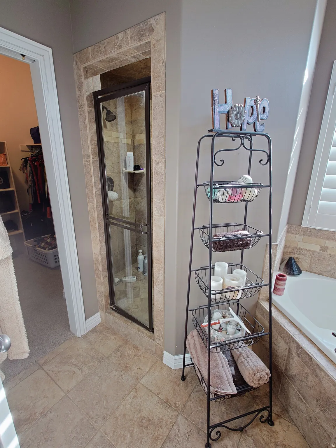 Full bath featuring a walk in closet, a bath, and a shower stall