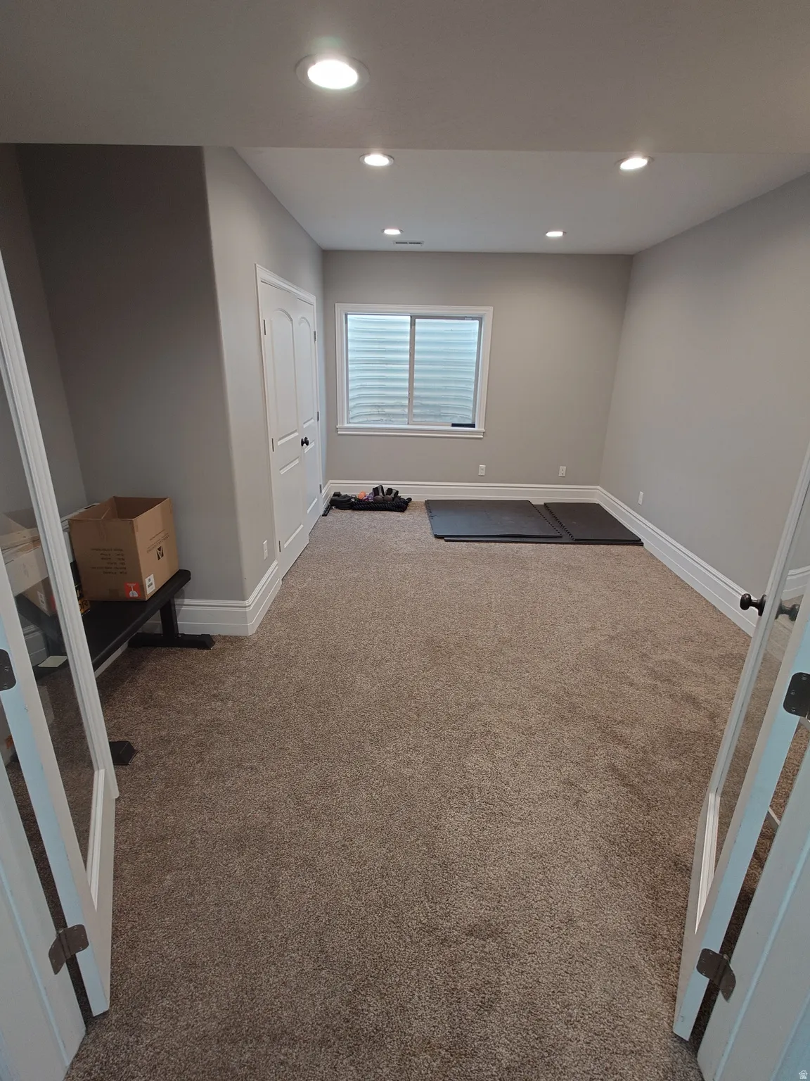Basement with recessed lighting and carpet floors