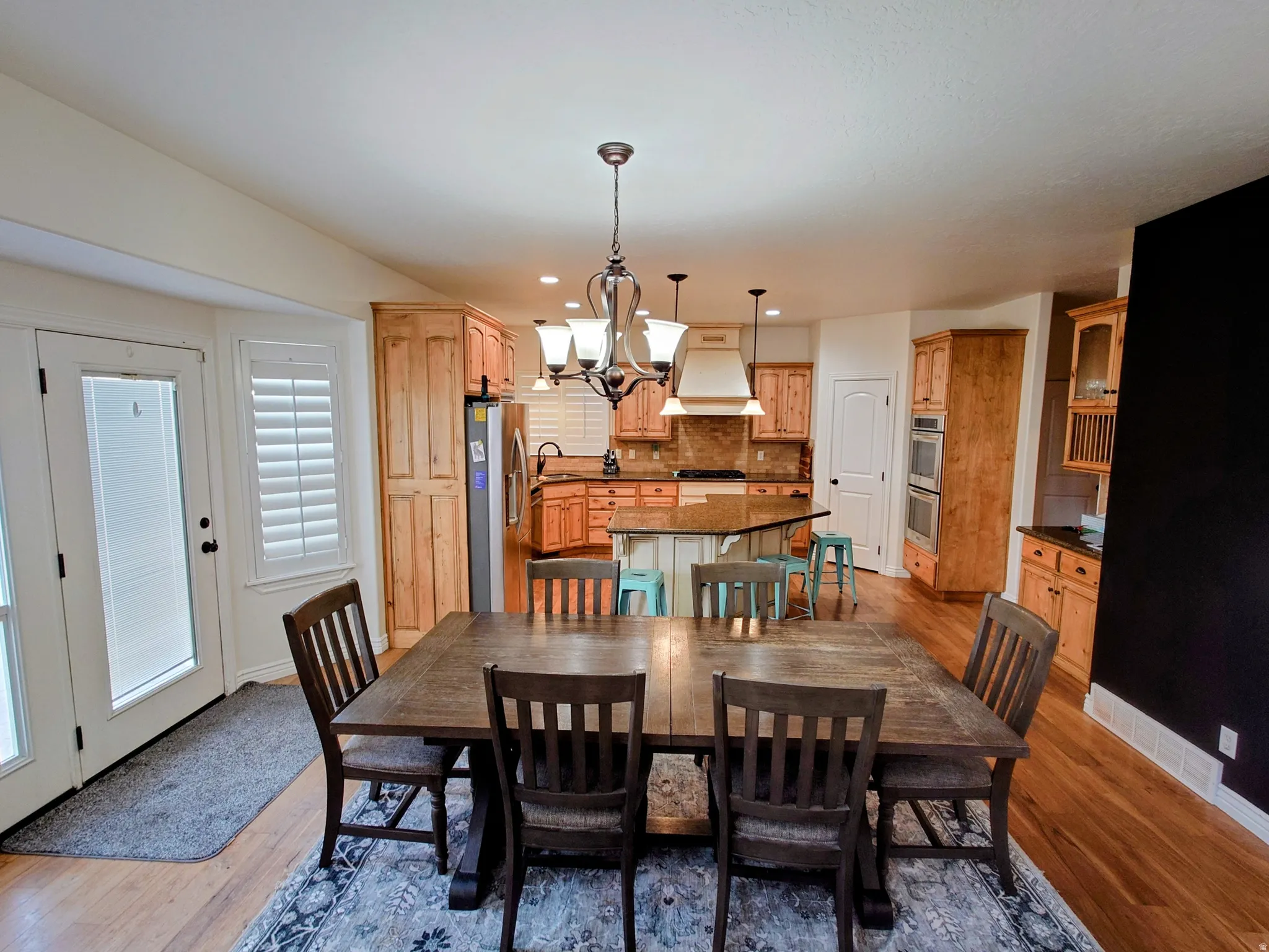 Dining room featuring a chandelier, recessed lighting, and light wood-style floors