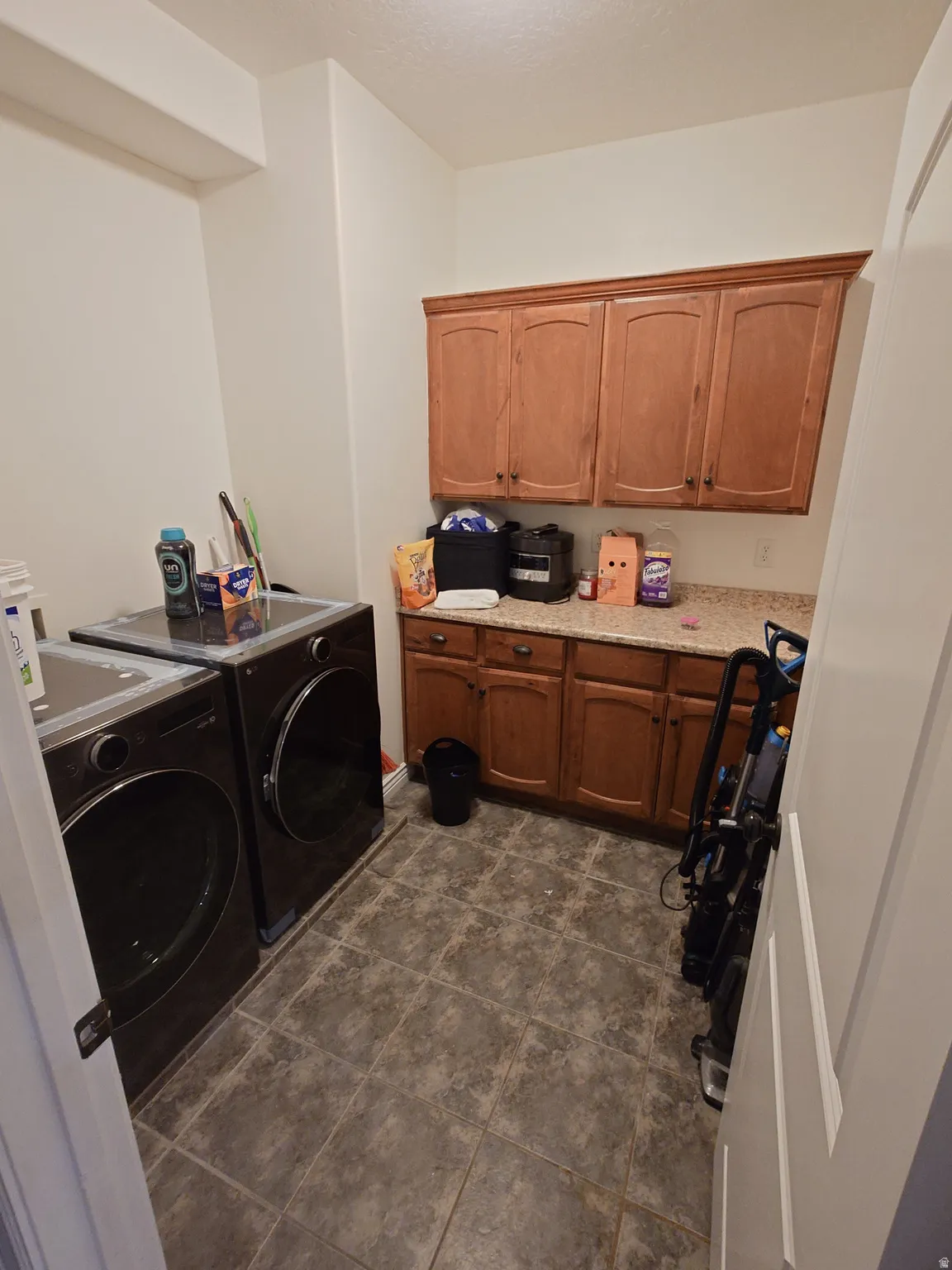 Laundry room with cabinet space and washer and clothes dryer