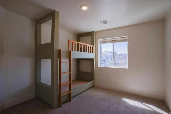 Unfurnished bedroom featuring carpet floors and baseboards