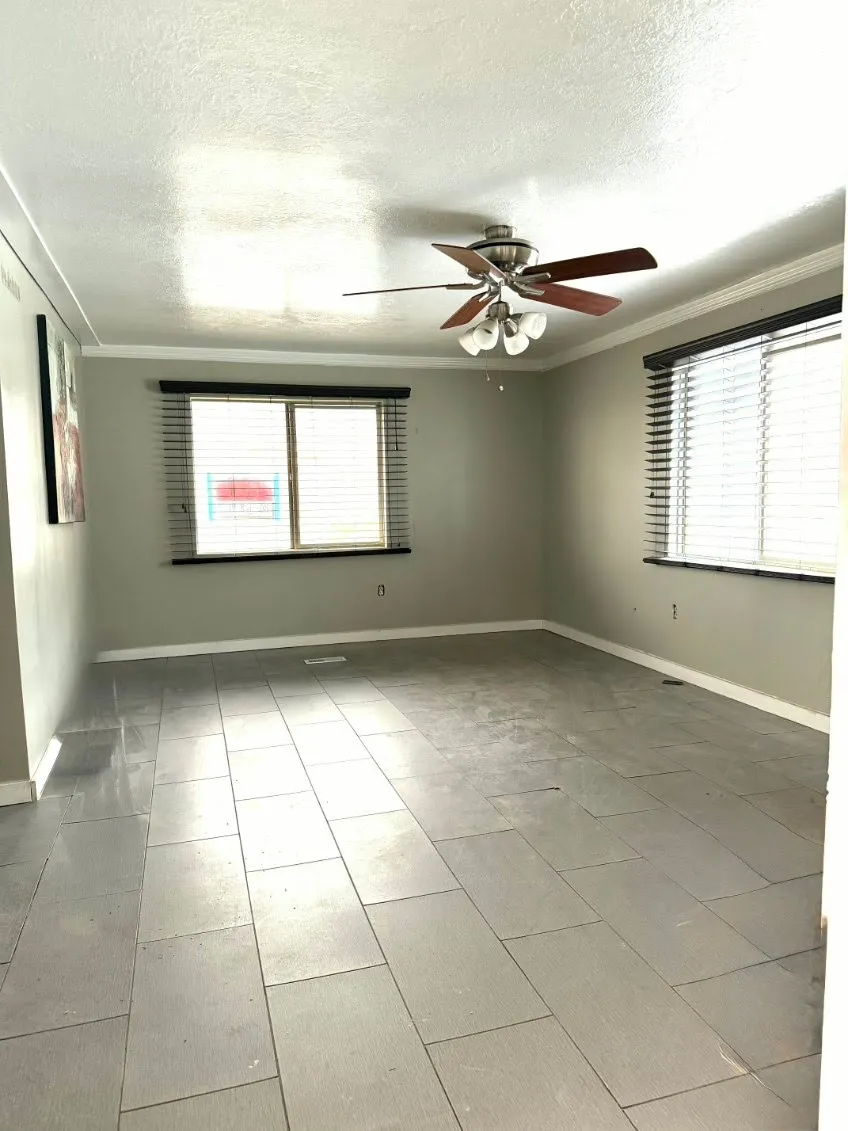 Unfurnished room with crown molding, a textured ceiling, and ceiling fan