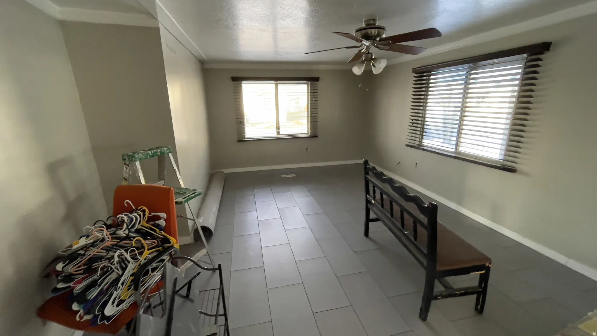 Spare room featuring ornamental molding, a ceiling fan, a textured ceiling, and tile patterned floors