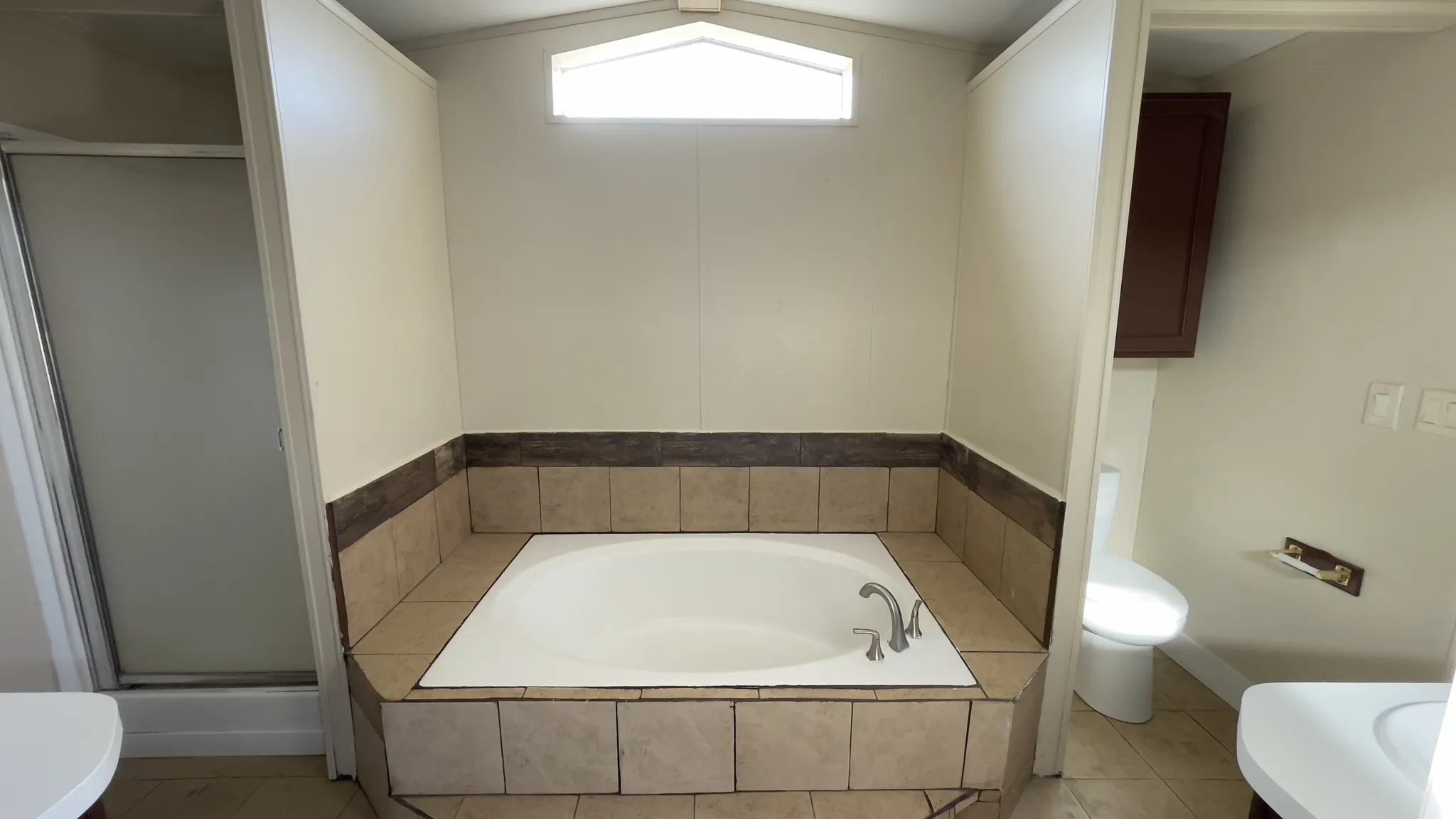Bathroom featuring a bath, vanity, a shower stall, and light tile patterned flooring