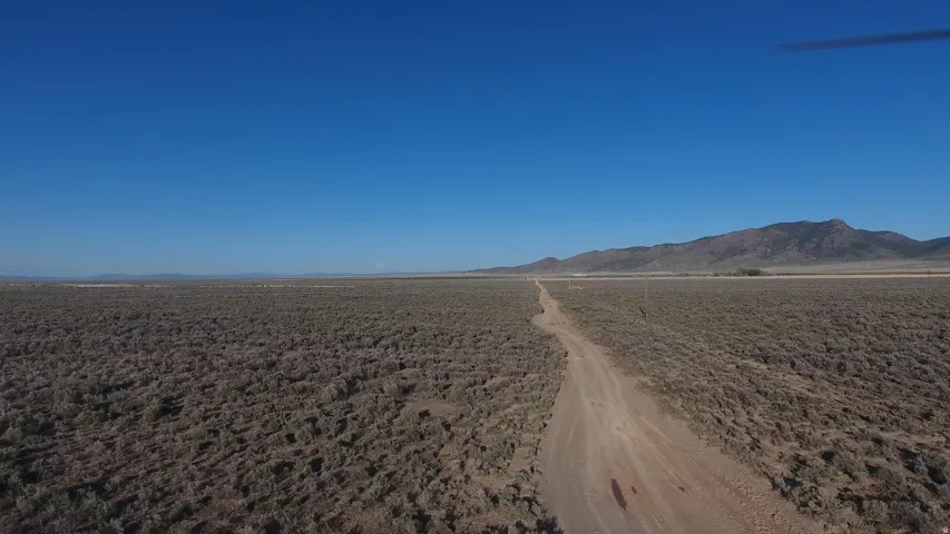 View of dirt / gravel road with a mountain view