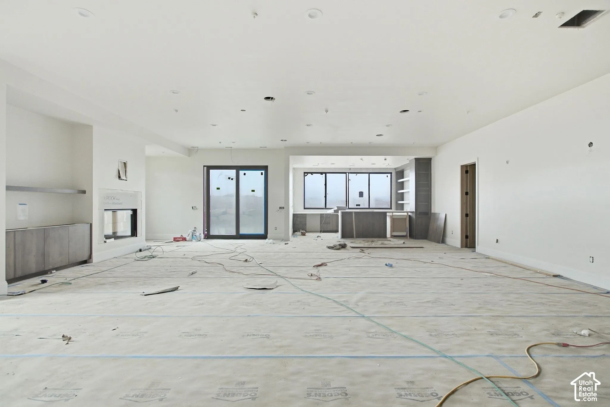 Recessed lighting, built-in fireplace, sliding glass door, built-in cabinetry, and integrated shelving