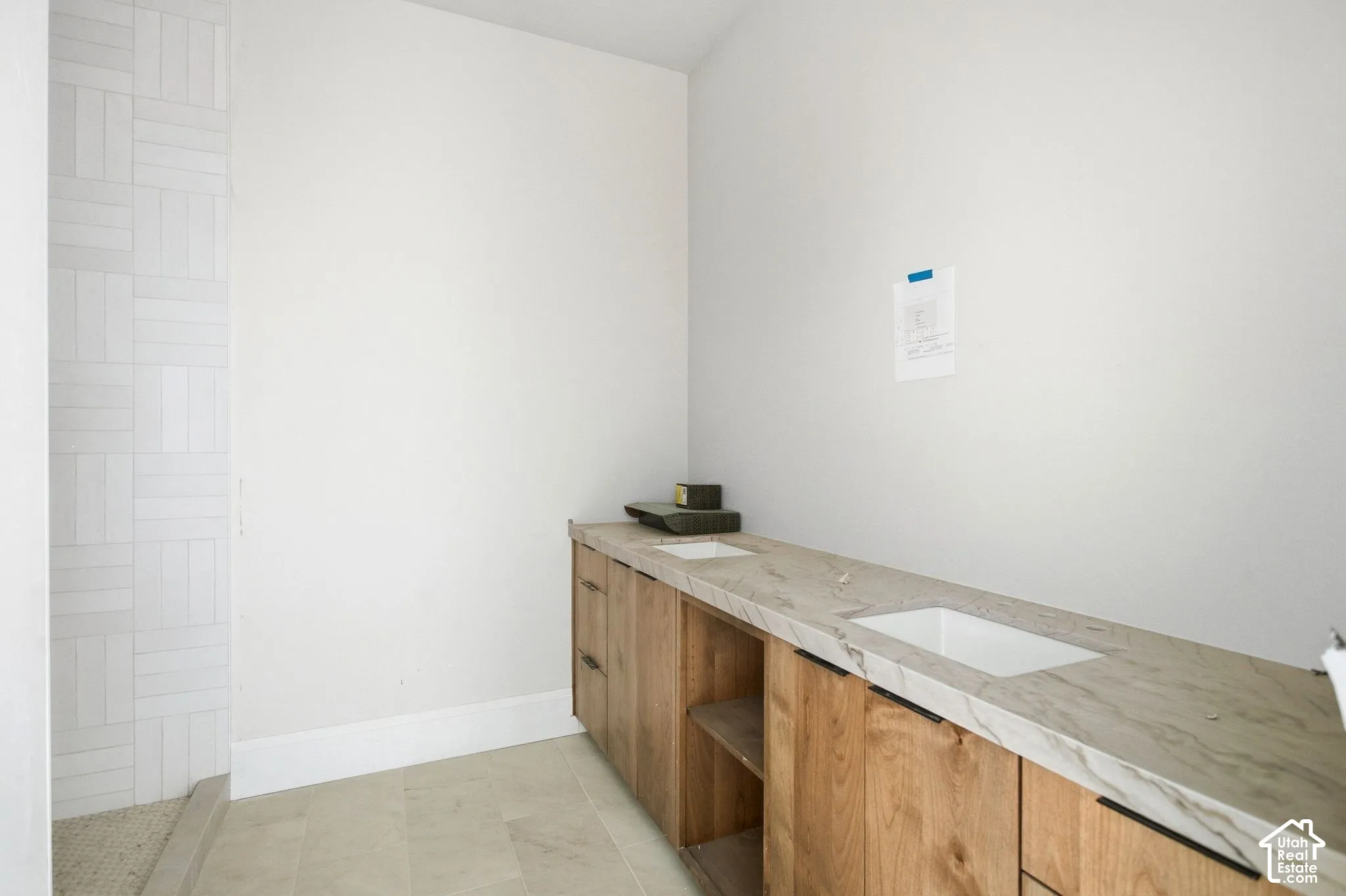 Wood-finish double vanity with integrated rectangular sinks and stone countertop