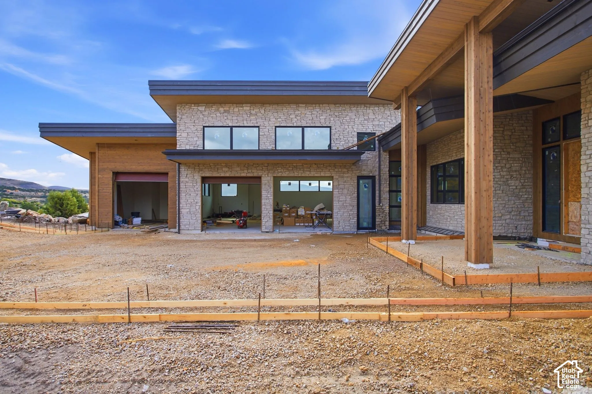Stone exterior with wood-clad pillars and dark trim