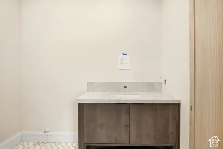 Vanity with a light-toned countertop and integrated rectangular sink