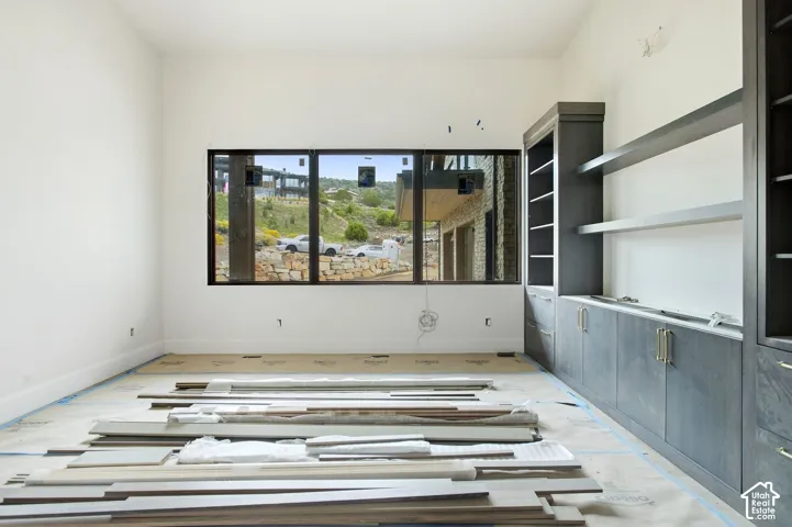Built-in cabinetry with open shelving, integrated drawers, and gold-finish hardware
