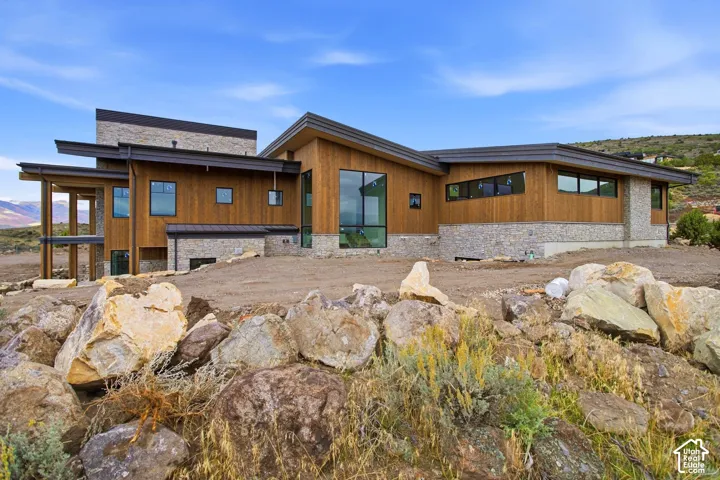 Contemporary exterior featuring natural wood siding and stone accents