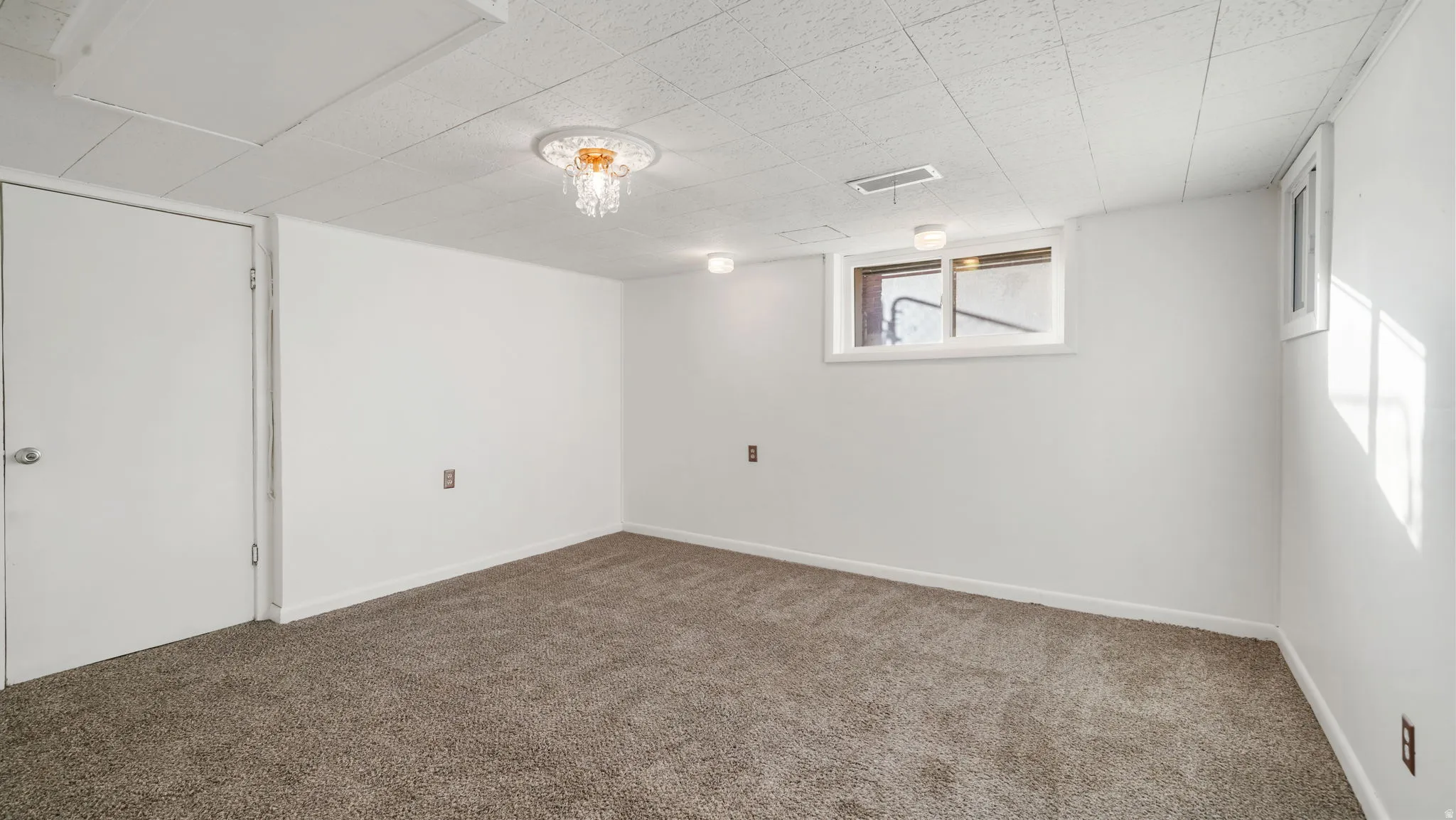 Below grade area featuring carpet and baseboards